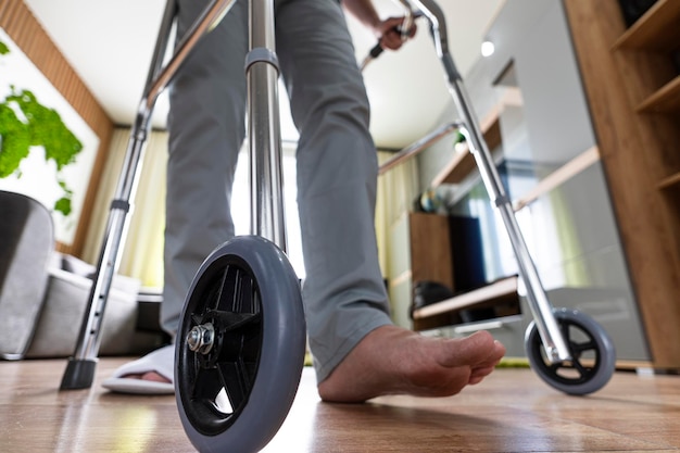 Sick person walks with the help of special devices for rehabilitation Walkers for adults rehabilitation after a broken leg or stroke