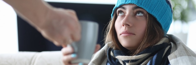 Sick woman drinking tea