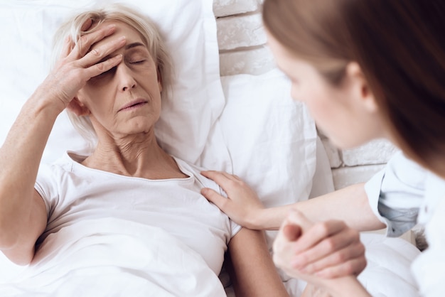 Sick woman has a headache in clinic