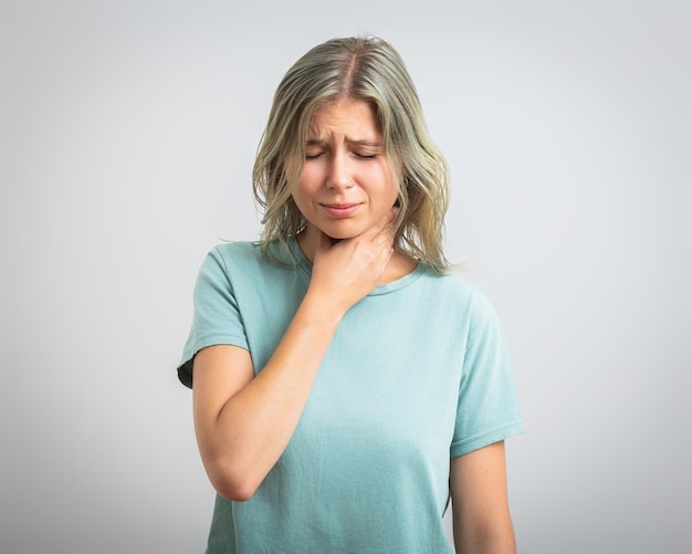 Photo sick woman having sore throat feeling sick holding hand on her neck