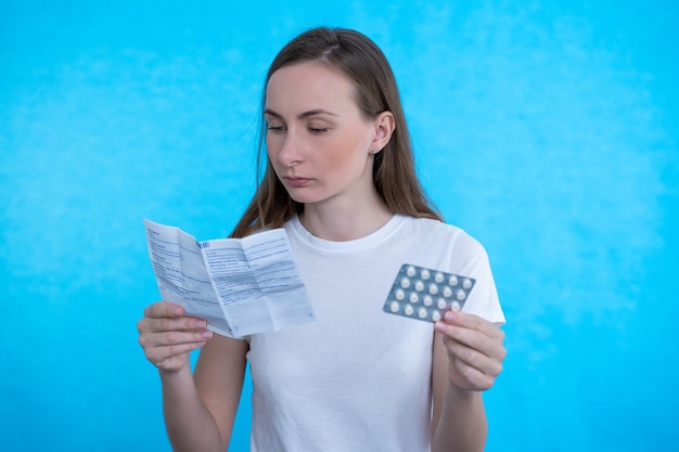 Sick woman looking at the explanation of the medicine before taking prescription medications