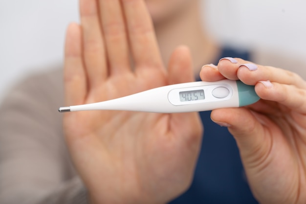 Sick women with a thermometer