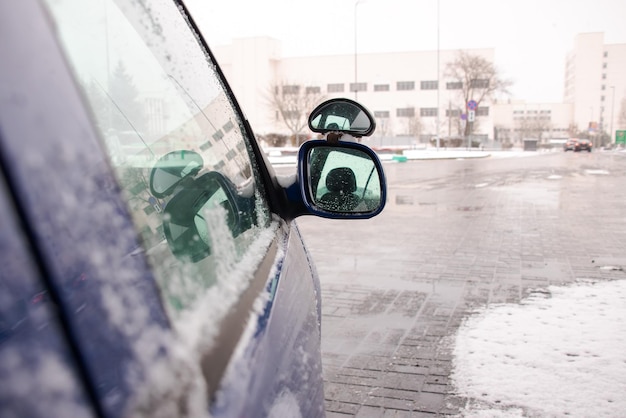 Side mirror of the car in the snow