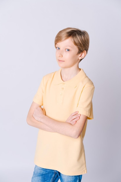 Side portrait modern teenager looking at camera thinking and smiling wearing