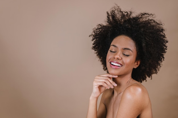 Side a smiling young Latin afro woman Joy positive and love Beautiful africanstyle hair