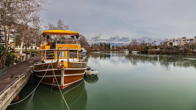 Side Turkey February 03 2023 boat for tourist travel are moored at the water channel Small yacht are tied to the river in a small tourist town