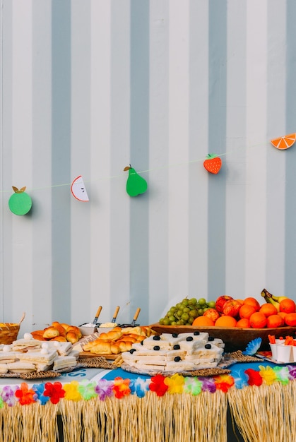 Side view of assortment of finger party food on a table with decorations