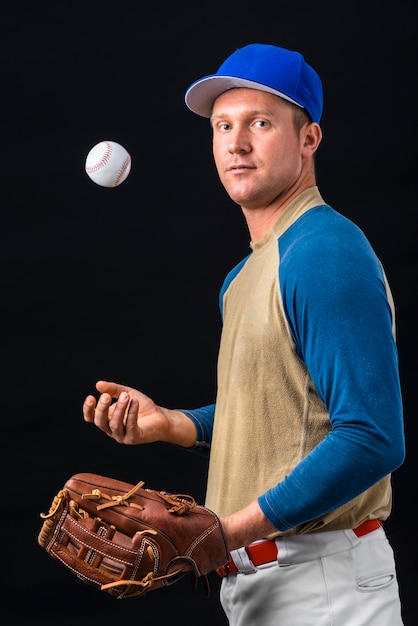 Side view of baseball player playing with ball