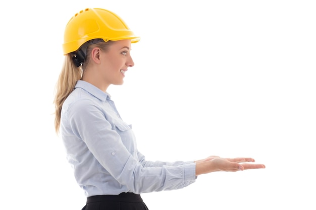 Side view of business woman in builder helmet holding something isolated on white background