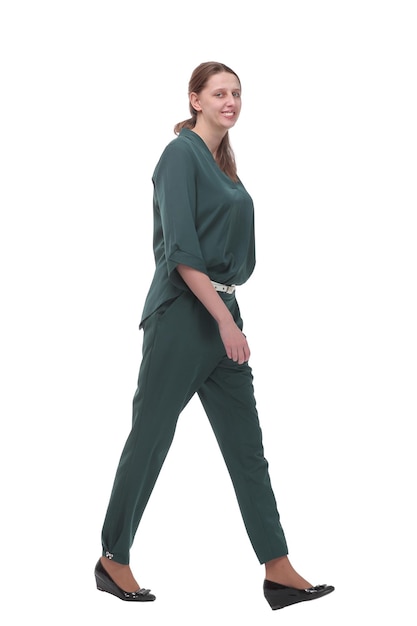 Side view of a business woman walking in full length on white background looking forward