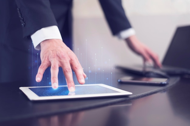 Side view of businessman using technology on tablet