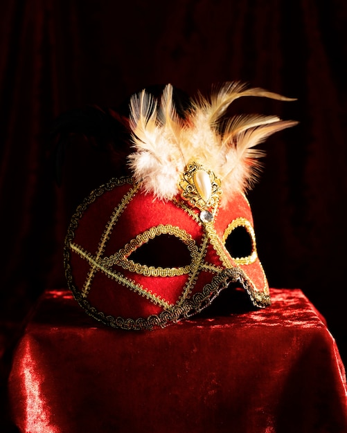 Side view of a carnival mask standing on a pedestal