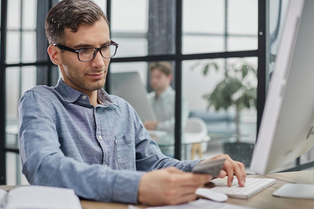 Side view ceo businessman using typing on computer pc laptop working in contemporary office