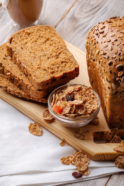 Side view on cereal bread loafs on the wooden decorated background