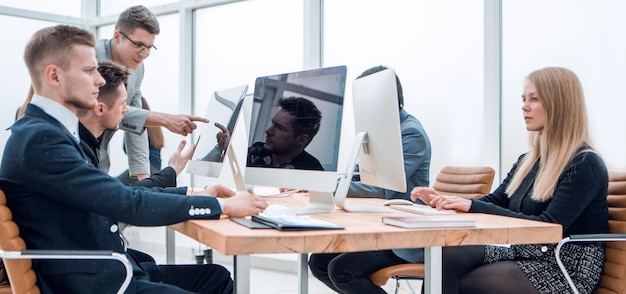 Side view confident young businessman sitting at the office Desk