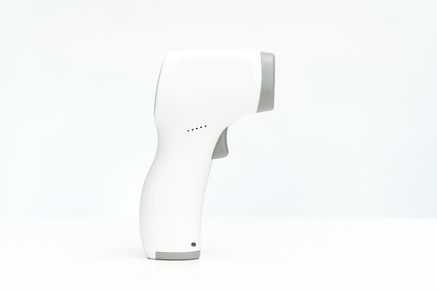 Side view. contactless electronic thermometer on a white background. measuring device for measuring body temperature. home medicine cabinet. sale of medical products for home use.