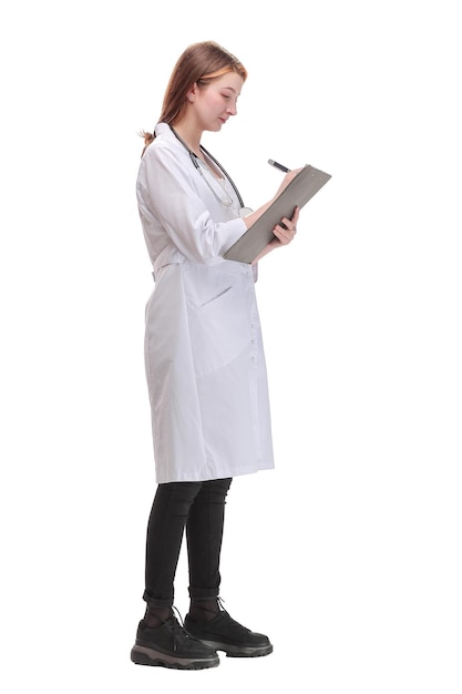 Side view of female doctor filling up medical form on clipboard