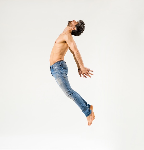 Side view of fit man jumping