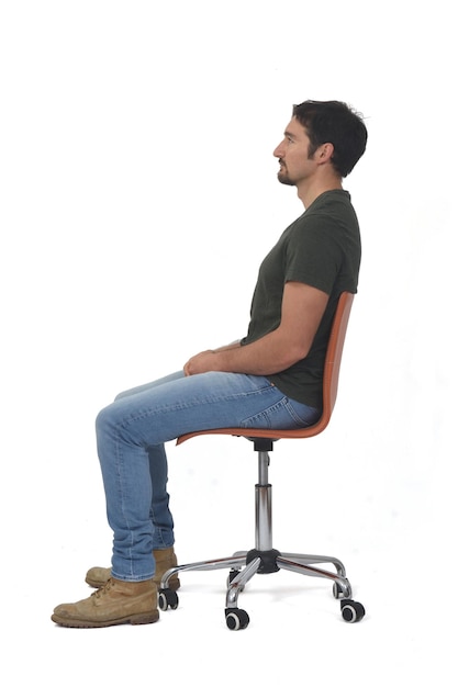 Side view of a full portrait of man sitting on chair on whige background