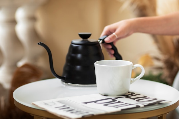 Side view hand holding coffee pot