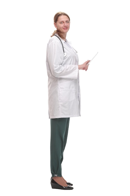 Side view of happy female doctor writing patient chart on digital tablet