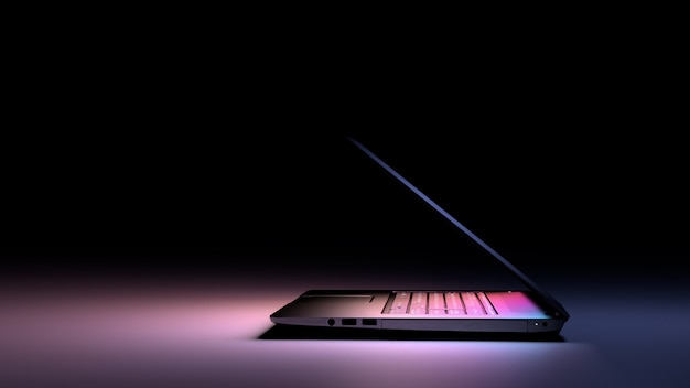 Side view of laptop PC with color light on dark. Technology Gaming concept.