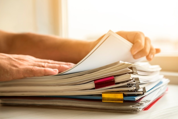 Side view man arranging business files