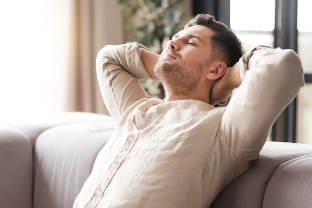 Side view man relaxing on the couch