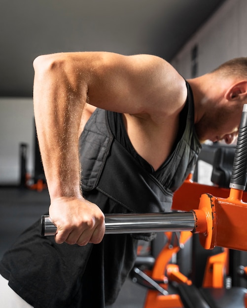 Side view man training at gym