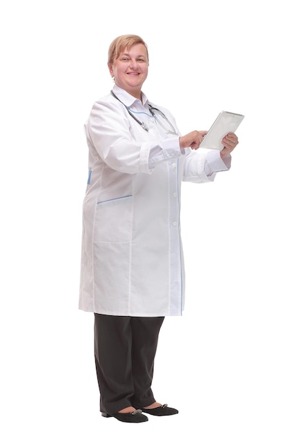 Side view of a middle age smiling doctor using a tablet computer - isolated over a white background