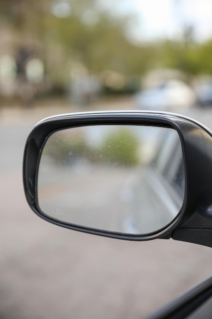 A side view mirror of a car shows the air vents on the side.