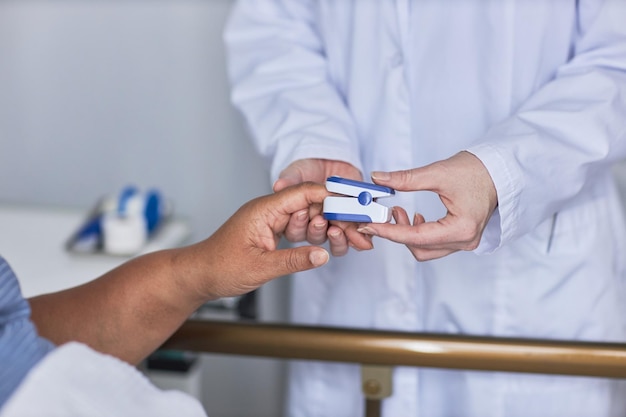 Side view of nurse measuring oxygen saturation of senior female patient