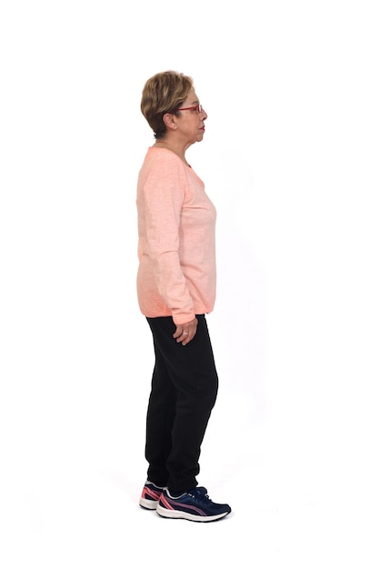 Side view o f a full portrait of senior woman with sportswear on white background