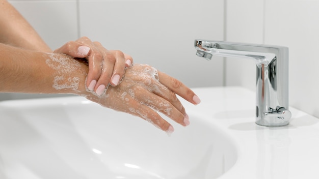 Side view person washing hands