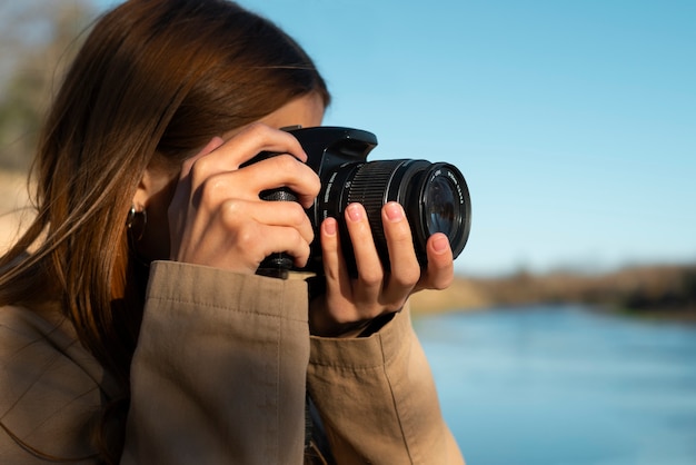 Side view photographer with camera