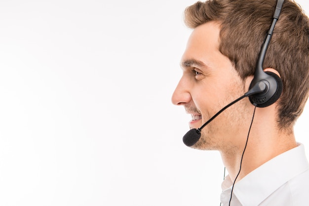 A side-view portrait of young smiling agent of call-center