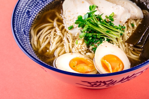 Side view on shio ramen noodle thick soup with chicken and eggs