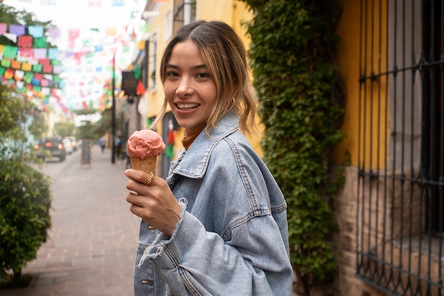 Side view smiley woman holding ice cream