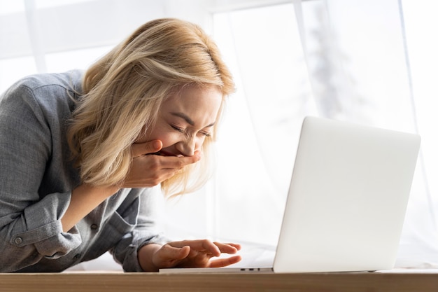 Side view of smiley woman with laptop