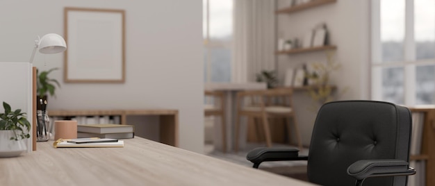 Side view of a space on a wooden table with office accessories in a modern bright office room