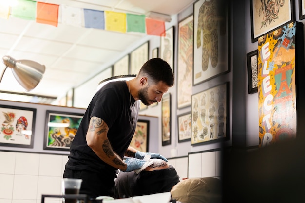 Side view tattoo artist at work