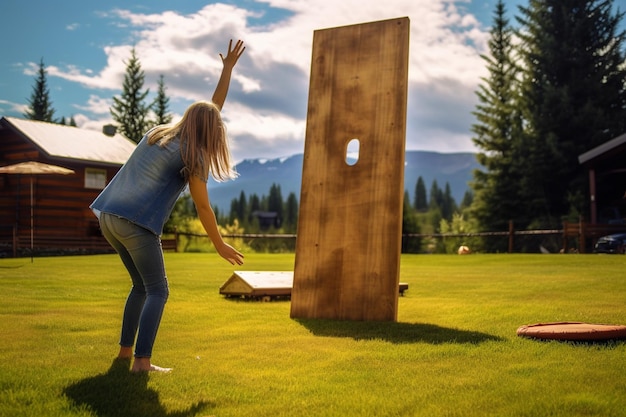 Photo side view of a teenager throwing a bean bag while playing cornhole with homemade wooden boards