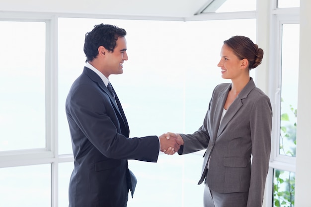 Side view of trades partner shaking hands