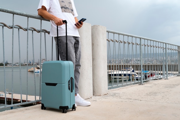 Side view traveler with suitcase