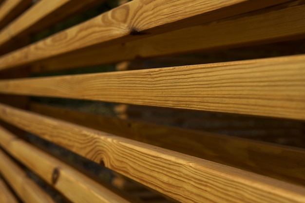 Side view of wall of brown wooden beams in gazebo in nature Beauty of geometry