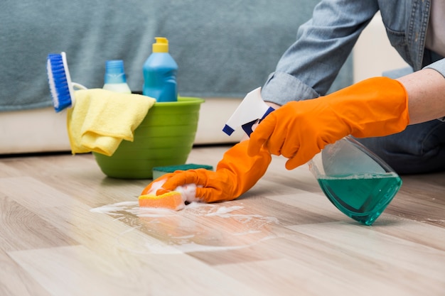 Side view of woman cleaning the floor