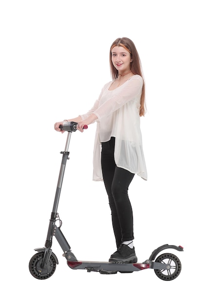 Side view of woman enjoying riding with electric scooter on white background