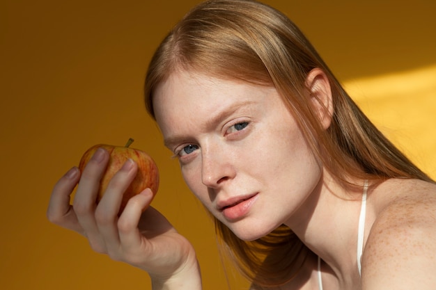 Side view woman holding apple