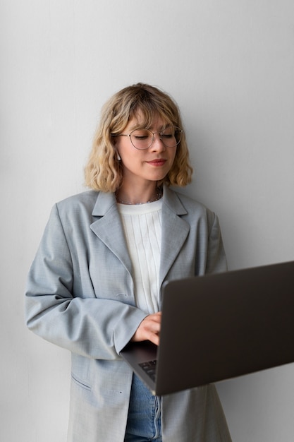 Side view woman holding laptop