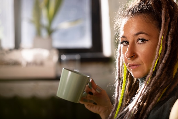 Side view woman holding mug